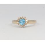 A 14ct yellow gold heart shaped blue topaz and diamond cluster ring size K 1/2, 2.3 grams