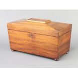 A 19th Century mahogany twin compartment tea caddy of sarcophagus form, raised on bun feet 16cm x