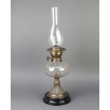A Victorian faceted glass oil lamp reservoir raised on an embossed gilt metal base with black glazed