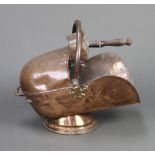 A 19th Century copper helmet shaped coal scuttle with shovel (some dents in places)