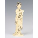 A Meiji period Japanese carved ivory figure of a standing lady, signed, 19cm