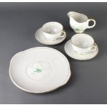 A Susie Cooper Clematis pattern part tea set comprising 8 tea cups (1 chipped), 8 saucers, 2 small