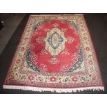 A red and blue ground Persian carpet with central medallion 384cm x 282cm Old moth damage and