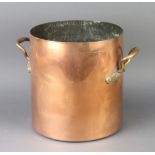 A cylindrical copper twin handled stock pot 26cm h x 25cm diam.