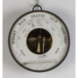 An aneroid barometer with enamelled dial contained in a circular metal case 20cm