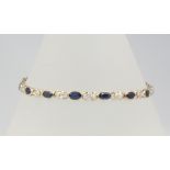 A 9ct yellow gold diamond and sapphire bracelet 18cm, 6.6 grams