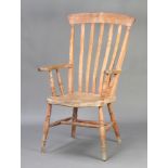 A 19th Century bleached beech and elm stick and rail back kitchen carver chair, raised on turned