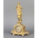 An Edwardian timepiece with paper dial and Arabic numerals contained in a gilt painted spelter