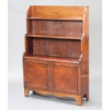 A 19th Century mahogany 3 tier waterfall bookcase, fitted a cupboard enclosed by a pair of