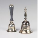 A silver hand bell London 1975 together with a ditto with wooden handle, gross 210 grams