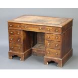 A Victorian bleached walnut kneehole desk/writing table with cross and feather banded top, inset