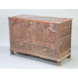 A 17th/18th Century heavily carved oak mule chest with hinged lid, original iron plate hinges and