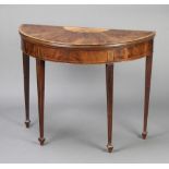 An Edwardian Sheraton Revival inlaid mahogany demi-lune card table with crossbanded top, raised on