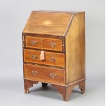 An Edwardian inlaid mahogany bureau, fall front revealing a fitted interior above 3 long graduated