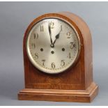 An Edwardian striking bracket clock with silvered dial and Arabic numerals contained in an inlaid