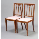 A pair of Edwardian Georgian style stick and rail back bedroom chairs with upholstered seats on