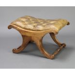 A Georgian style bleached mahogany framed stool upholstered in green buttoned leather with turned