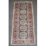 A red and blue ground Afghan rug with 6 octagons to the centre within multi row border 210cm x