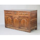 An 18th Century oak dresser base fitted 1 short and 2 long drawers above pair of arched panelled