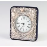 A silver repousse quartz timepiece, rubbed marks, 11cm