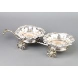 A Victorian silver plated 2 section decanter wagon with scroll rims with 4 spoked wheels and