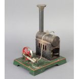 A tin plate model of a stationary steam engine marked DC complete with funnel 22cm h x 12cm x