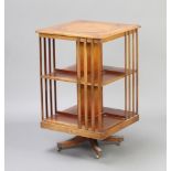 A Victorian style square mahogany 2 tier revolving bookcase, upper section with circular inset