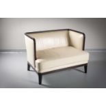 A LEATHER UPHOLSTERED TWO SEAT CHAIR BACK SOFA by Andree Putman