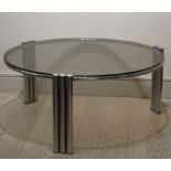 A CHROME CIRCULAR LOW TABLE, FRENCH 1970s, on tubular supports, with glass top, 83cm diam x 60cm (