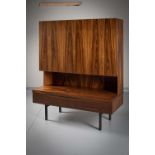 A ROSEWOOD SIDE CABINET, DANISH 1970s, the cupboard doors, above a shelf and drawer, on metal