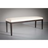 A RECTANGULAR UPHOLSTERED STOOL by Andree Putman