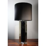 A CHROME AND MIRRORED TABLE LAMP, ITALIAN, the faceted column on square base, 110cm (h)