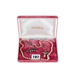 A GRADUATED CULTURED PEARL NECKLACE with silver marcasite clasp, 18 ins long,