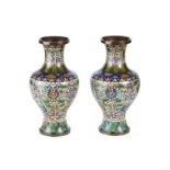 A PAIR OF EARLY 20TH CENTURY CHINESE CLOISONNE ENAMEL VASES with all over flower and leaf