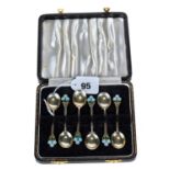 A SET OF SIX ENGLISH SILVER AND ENAMEL COFFEE SPOONS with flower head terminals, maker T & S,