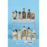 AN EARLY 20TH CENTURY JAPANESE CARVED AND DECORATED IVORY CHESS SET of figural form,