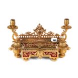 A 19TH CENTURY FRENCH ORMOLU INKSTAND with pen well, hinged compartment and twin candle holders,