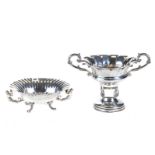 A CONTINENTAL OVAL FLUTED SILVER FRUIT BOWL, winged figure handles raised on scroll feet,