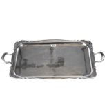 A GEORGE V SILVER DOUBLE HANDLED TEATRAY of shaped rectangular outline, engraved inscription,