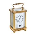 AN EARLY 20TH CENTURY FRENCH BRASS 8 DAY CARRIAGE CLOCK with white enamel dial and chain link