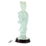 A CHINESE PALE GREEN HARDSTONE FIGURE OF A FEMALE holding a fan, wooden base, 6 ins high.