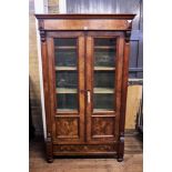 A 19TH CENTURY CONTINENTAL WALNUT CABINET, the three quarter glazed doors with drawer below,