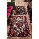 A 20TH CENTURY HAMADAN RUG, central panel on a cream ground with three outer guard stripes,