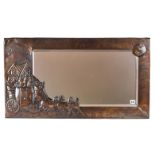 AN UNUSUAL EARLY 20TH CENTURY RECTANGULAR BEATEN COPPER WALL MIRROR with raised coach and horses