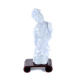 A CHINESE LAVENDER JADE FIGURE OF GUANYIN, 4 1/4 ins high with scrolled wooden stand.