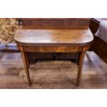 A SHERATON PERIOD MAHOGANY CARD TABLE, the reeded edge "D" shaped top above an ebony strong frieze,