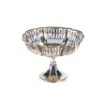 A GEORGE V PIERCED SILVER PEDESTAL BON BON DISH raised on a shaped foot-ring, maker:- C & S Ltd,