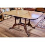 AN EARLY 19TH CENTURY MAHOGANY CUMBERLAND-ACTION DROP FLAP DINING TABLE raised on four turned