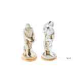 A PAIR OF LATE 19TH/EARL 20TH CENTURY JAPANESE PORCELAIN FAUX-IVORY FIGURES each on simulated tusk