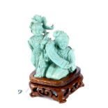 A CHINESE CARVED TURQUOISE GROUP of a kneeling girl with a scroll and a boy with a lily,